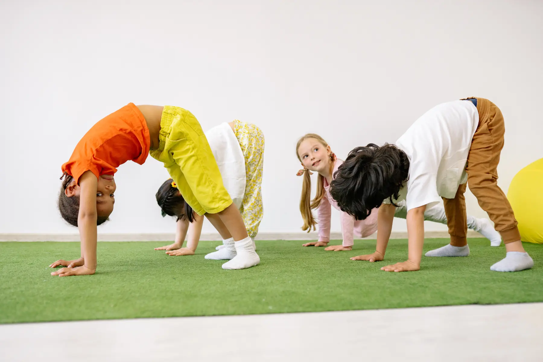 Niños practicando postura de yoga
